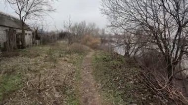 cloudy landscape on the banks of the river. natural landscape with water. walk by the water. Narrow path over a cliff. Water break. Strong wind near the river. Winter beach. Without people. Ukrainian nature. Ukraine.