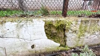 cracks in the foundation. destroyed foundation. Effect of an old tuff wall that is about to break to mean a concept. cracked collapsed wall. Crack in the Foundation of an old house