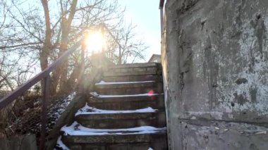 concrete stairs in winter. snow on the stairs. stairs and white snow. Steps in the snow at entrance to the building in winter, slippery stairs. Old concrete staircase on the banks of the Dnieper river