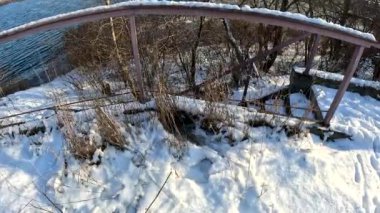 dry grass under snow.Gentle fluffy snowflakes covering dry grass on frozen field sunny winter day. Frozen dried grass covered soft fallen snow close up. cold season nature.