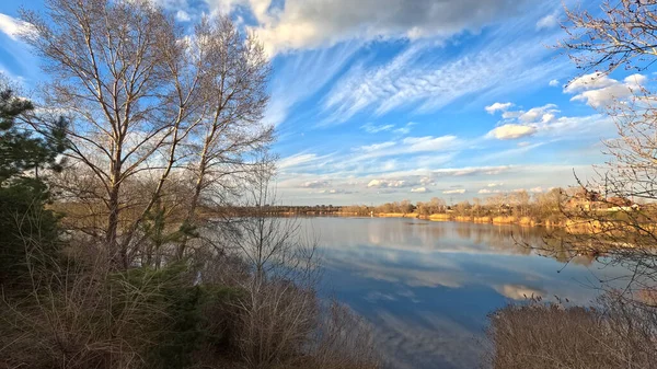 landscape on the river. reflection of the sky in the water. on the shore. rivers. natural landscape with water. sunny evening on the lake. Ukrainian landscape. Dnepr River. Calm water at sunset.