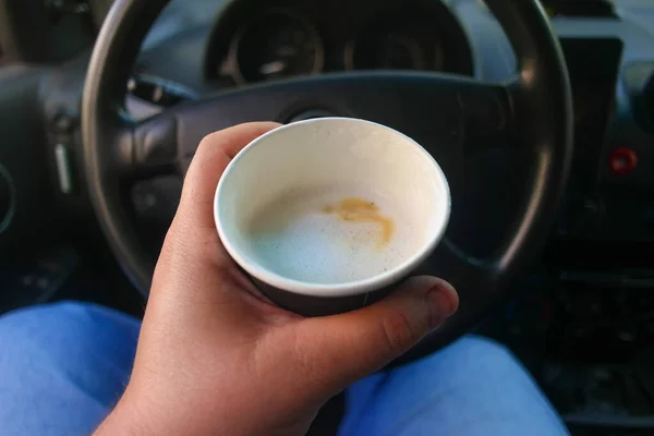 coffee in the car. cappuccino in a paper cup. coffee in a paper cup. latte in the car.