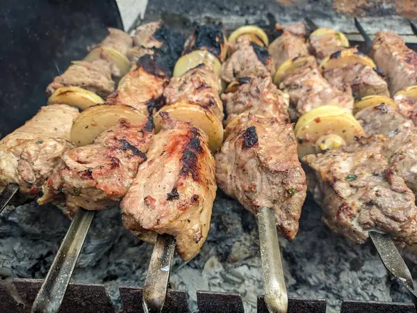Barbeküde ızgara lezzetli yemeklere yakın çekim. Doğada lezzetli şiş kebap pişirme süreci. BBC 'deki metal şişte lezzetli yemekler. Piknik zamanı. Sokak yemeği. Yemek festivali. shashlik.