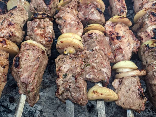 Barbeküde ızgara lezzetli yemeklere yakın çekim. Doğada lezzetli şiş kebap pişirme süreci. BBC 'deki metal şişte lezzetli yemekler. Piknik zamanı. Sokak yemeği. Yemek festivali. shashlik.