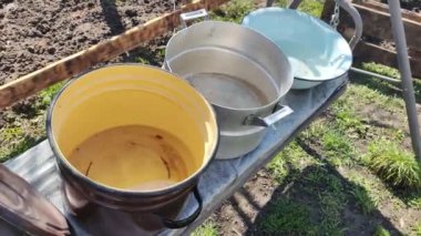 Birkaç boş tava. Büyük kaplar dolusu su. bir sürü renkli tencere.