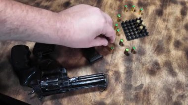 Silah ellerinde. Adam silah dolduruyor. Silah ve fişekler. - Silah. Nefsi müdafaa. Çekim. Mermiler ve silah ellerinde..
