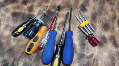 Masada farklı tornavidalar var. Düz ve yıldız tornavidaları. Çok renkli tornavidaların yakın çekim görüntüsü. Beyaz arkaplanda izole edilmiş, uzay nesnelerini kopyalayın. Kafası olan değiştirilebilir tornavida seti.