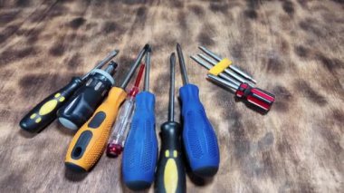 Masada farklı tornavidalar var. Düz ve yıldız tornavidaları. Çok renkli tornavidaların yakın çekim görüntüsü. Beyaz arkaplanda izole edilmiş, uzay nesnelerini kopyalayın. Kafası olan değiştirilebilir tornavida seti.