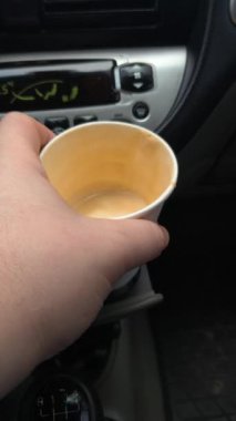 Arabada bir fincan cappuccino. Arabadaki kahve. Sürücü elinde bir içki tutuyor. Arabada bir bardak tutacağı. Şoförün elinde latte. Kâğıt kahve fincanı adamın elinde. Araba yola park edilmiş, gezginin sıcak kahvesi.