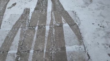 Buzda lastik izleri. Yerde tekerlek izleri var. Karda lastik izleri var..