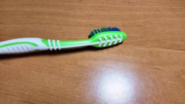 Ellerinde yeşil diş fırçası. Diş fırçasıyla yavaş çekim videosu. Diş fırçası. çok renkli diş fırçaları. Yavaş çekim videosu. 4K biçiminde yüksek kaliteli video.