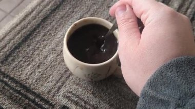 Ellerinde güzel bir fincan kahve. Sıra dışı bardak. Bir fincan kil çay. Kahve içen bir adam. Çay içen adam. canlı kamera.