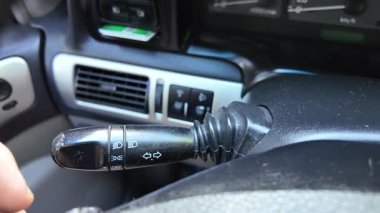 Sürücü dönüş sinyalini açar. Şoför kolu kaydırıyor. Arabayı kontrol eden kişi..