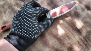 knife with brown handle. knife with sheath. brown vintage knife in hands. 4k video in high definition