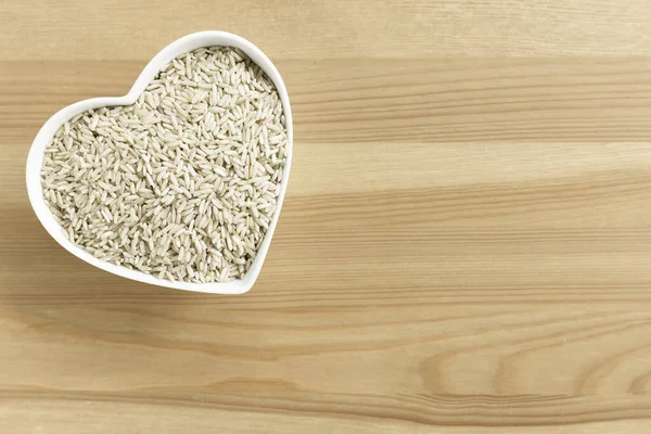 Flat Lay Dried Brown Rice Heart Shaped Bowl Copyspace Stockbild