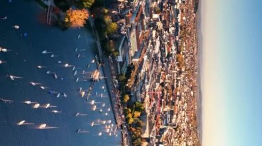 Aerial view of old town Zurich, Limmat river and lake Zurich on a fall day in Switzerland largest city. Aerial vertical, vertical video background.