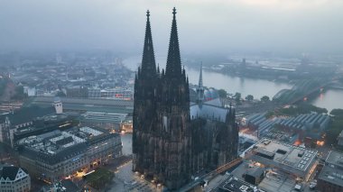 Aerial drone shot, Cologne, Germany in bad foggy weather, flight over old town, Cologne cathedral clipart