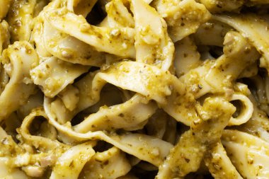 close up of italian basil pesto pasta food background