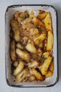 Bir tepsi kızarmış patates dilimini yakın.