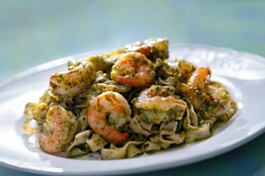 Pesto soslu bir tabak deniz mahsulü makarna.