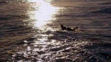 Surfing in spain, Sitges town, sunset. High quality 4k footage