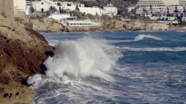 Big waves crash against the rocky shore. High quality 4k footage