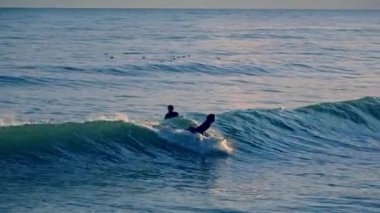 Surfing in spain, Sitges town, sunset. High quality 4k footage