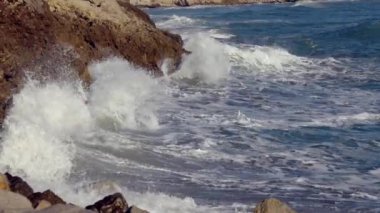 Big waves crash against the rocky shore. High quality 4k footage