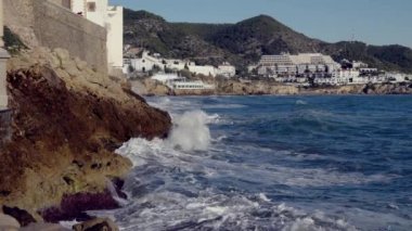 Big waves crash against the rocky shore. High quality 4k footage