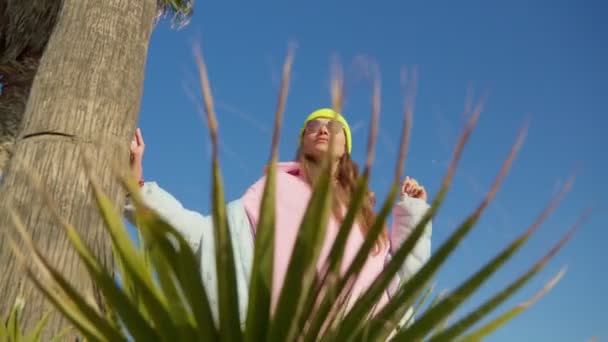 Girl Palm Leaves Camera Moves Bright Sunny Day — Stock videók