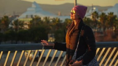 A girl with glasses walks along the yacht club. High quality 4k footage