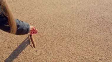 A girl draws a heart on the beach. High quality 4k footage