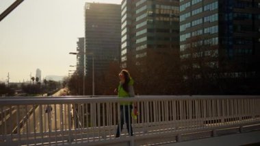 Gün batımında bir kız köprüden geçer. Yüksek kalite 4k görüntü