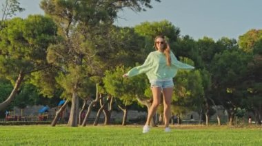 Parkta sevinçten zıplayan bir kız. Yüksek kalite 4k görüntü