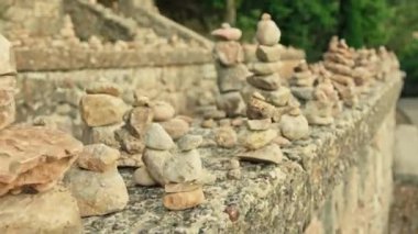 Arka planda üst üste yığılmış birden fazla kaya yığını oluşturur..