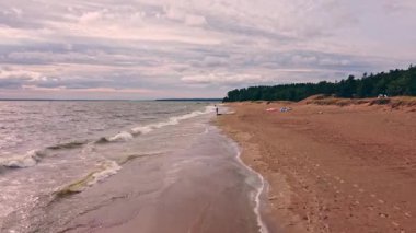 Yumuşak dalgalar sakin kumlu bir sahili öper. Yalnızlığın akşam melteminin fısıltılarını taşıdığı ve bulutların alacakaranlık renklerinde sürüklendiği yerde..