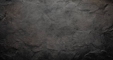 Kumlu taş desenli pürüzlü siyah duvar.