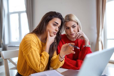 Akıllı kız öğrenciler ödev projesi hakkında tartışıyorlar dizüstü bilgisayardan bilgi okuyorlar, özel ders izleyen genç kadınlar ofiste sohbet ediyorlar.