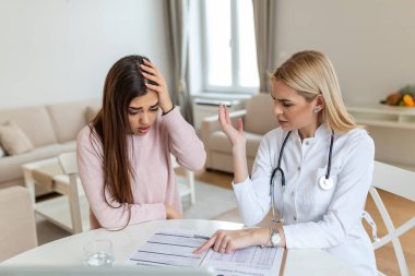 Hastane faturaları alan hasta, yüksek faturalar konusunda çaresiz durumda, doktor, hastasına tedavinin maliyetini gösteriyor..