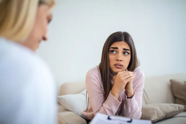 stock image Woman at therapy session. Attentive psychologist. Attentive psychologist holding pencil in her hands making written notes while listening to her client