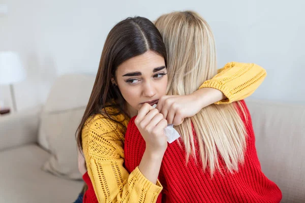 stock image Woman hugging her depressed friend at home, closeup. Young woman supporting her crying girlfriend. Friendship consoling and care, copy space