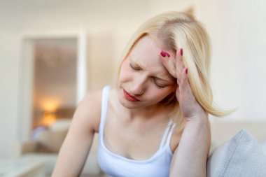Sinus ache causing very paintful headache. Unhealthy woman in pain. Sharp strong sore. Sinus pain, sinus pressure, sinusitis. Sad woman holding her head because sinus pain