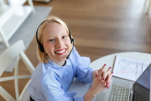 Cheerful woman wear headset laugh using laptop video stream conference call teach online, happy woman student gamer tutor have fun watch webinar web cam education entertainment concept
