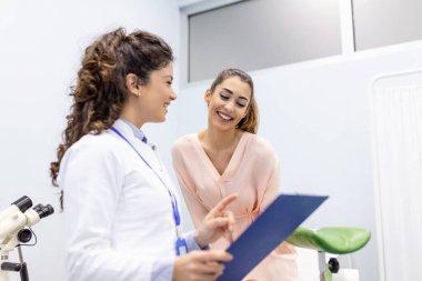 Treatment of cervical disease. Female gynecologist unrecognizable woman patient in gynecological chair during gynecological check up. Gynecologist examines a woman. Diagnostic, medical service. clipart