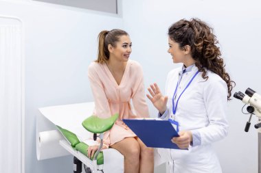 Treatment of cervical disease. Female gynecologist unrecognizable woman patient in gynecological chair during gynecological check up. Gynecologist examines a woman. Diagnostic, medical service. clipart