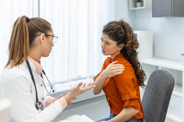 Young female professional doctor physician consulting patient, talking to adult woman client at medical checkup visit. diseases treatment. medical health care concept