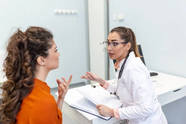 Young female professional doctor physician consulting patient, talking to adult woman client at medical checkup visit. diseases treatment. medical health care concept