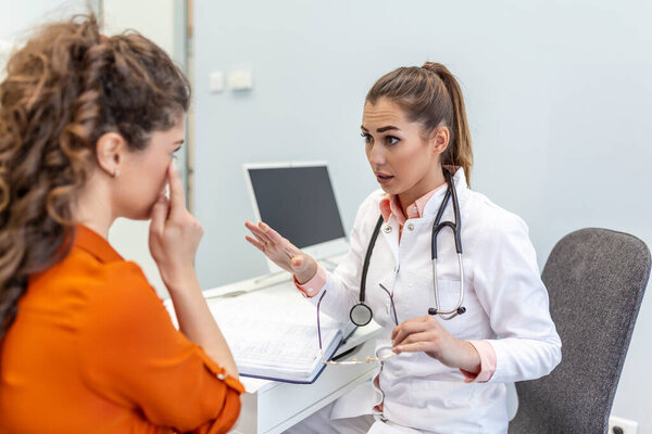 Young female professional doctor physician consulting patient, talking to adult woman client at medical checkup visit. diseases treatment. medical health care concept