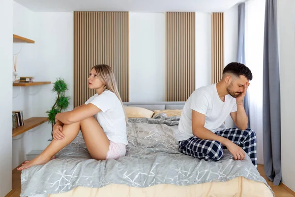 Relationship concept. Top view of young couple lying on the bed. Couple having a fight in the bed. concept about relationship and problems between couples. Sexual frustration. Lovers ignore each other