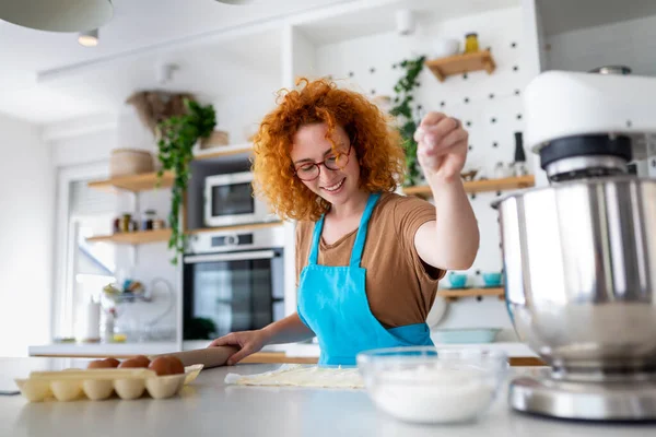 stock image Baking Concept. Portrait Of Joyful Woman Kneading Dough In Kitchen Interior, Cheerful Female In Apron Having Fun While Preparing Homemade Pastry,